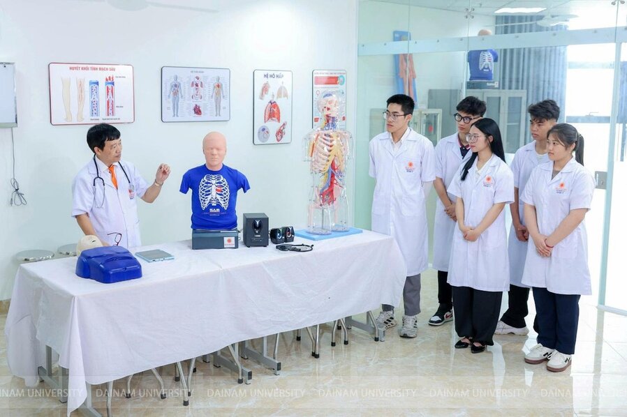 A group of people in white coats standing around a table

Description automatically generated