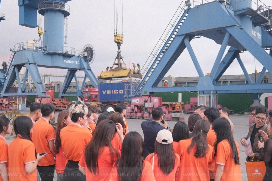 A group of people in orange shirts

Description automatically generated